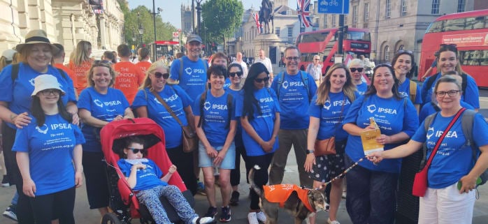 Group of IPSEA fundraisers and volunteers wearing blue IPSEA t-shirts, taking part in the London Legal Walk 2023