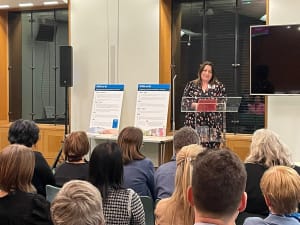 Photo of IPSEAs Chief Executive, Ali Fiddy, standing at a lectern presenting at IPSEAs 40th anniversary event at Portcullis House, House of Commons